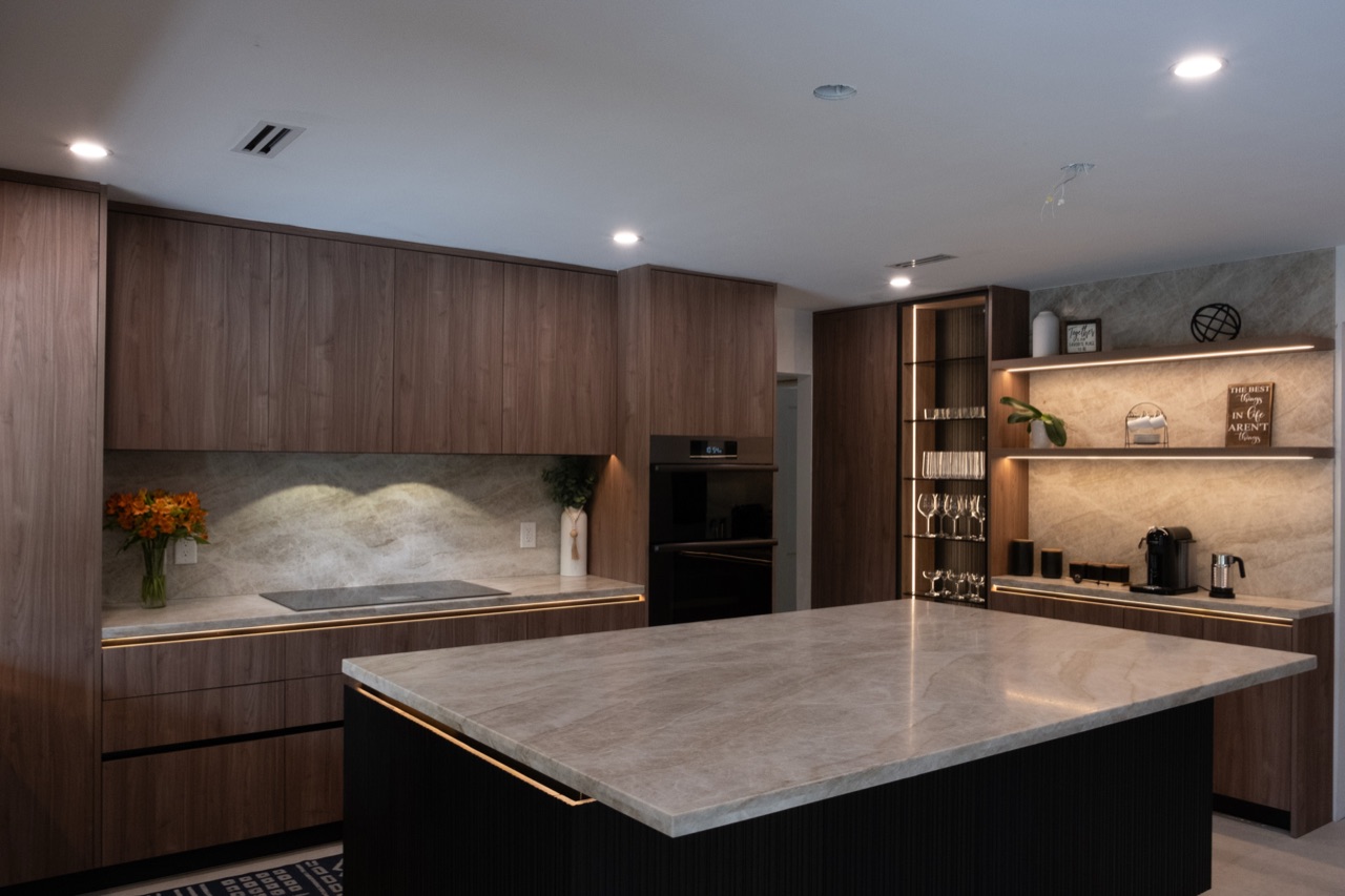 Custom modern kitchen with full-height cabinetry, large island and integrated storage.