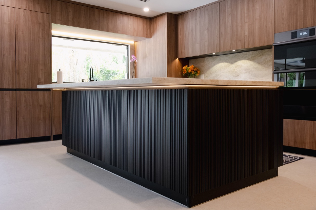 Modern custom kitchen combining wood cabinetry, concealed storage and integrated appliances.