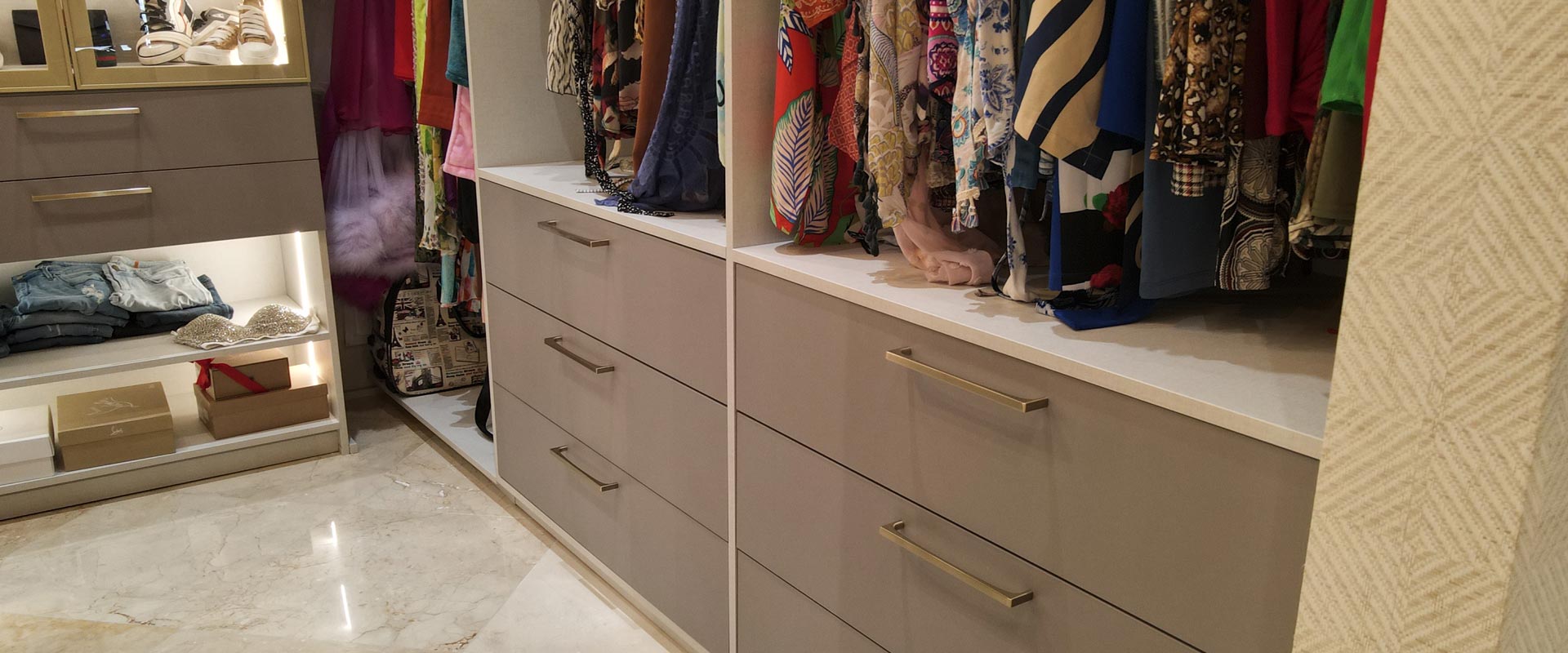 Closet rod and drawer layout with banks of drawers below a stone top and hanging garments above