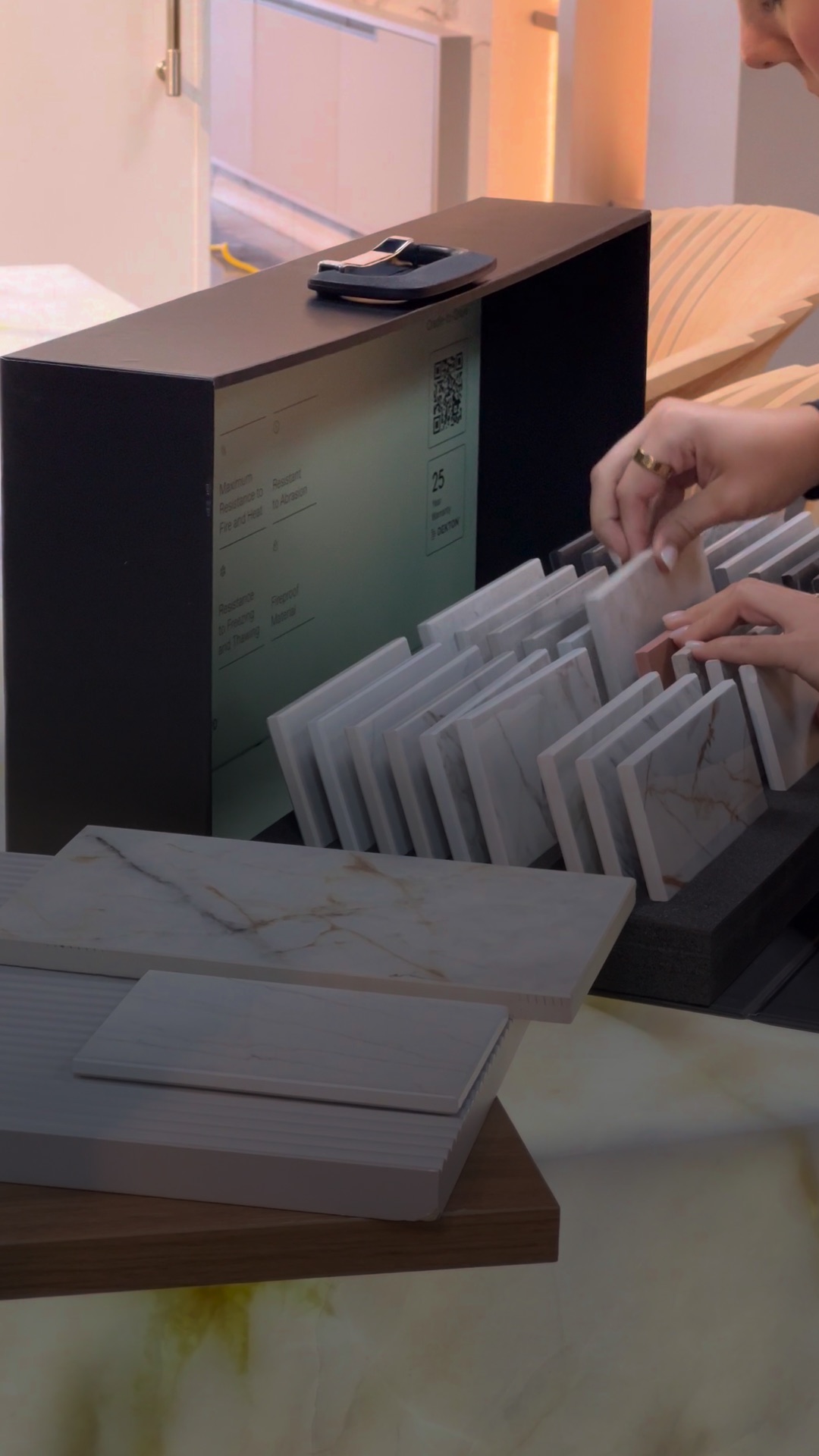 Selecting stone and countertop samples for a custom kitchen remodel, comparing marble-look slabs at the Doral studio.
