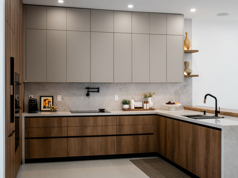 Contemporary custom kitchen in Miami with two-tone handleless cabinetry, walnut lowers, and a marble backsplash